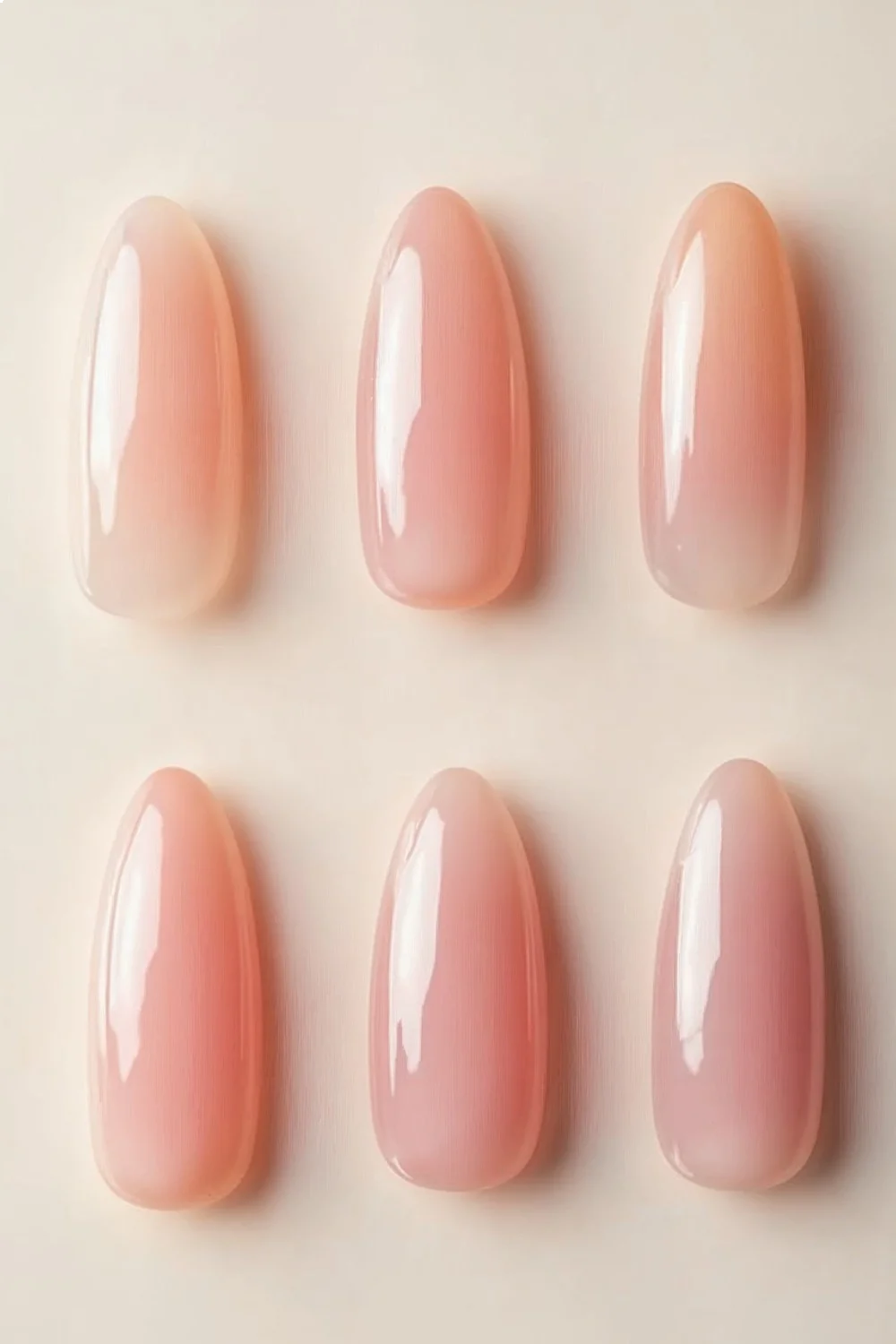 Close-up of almond nail shape in soft pink hues alongside rounded and oval shapes, highlighting the tapered peak