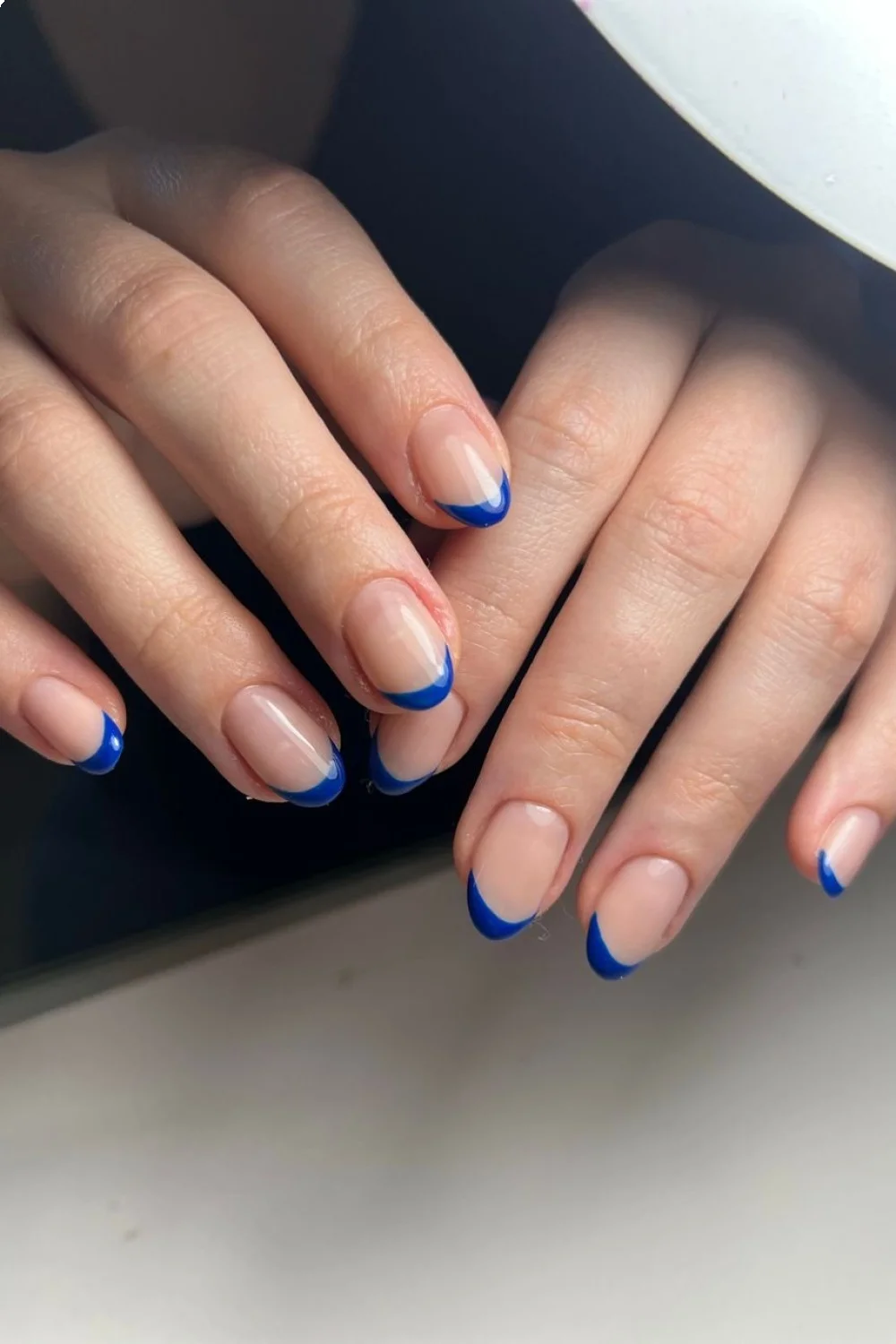 nude nails with bold blue straight-line French tips showcasing easy pretty nail designs