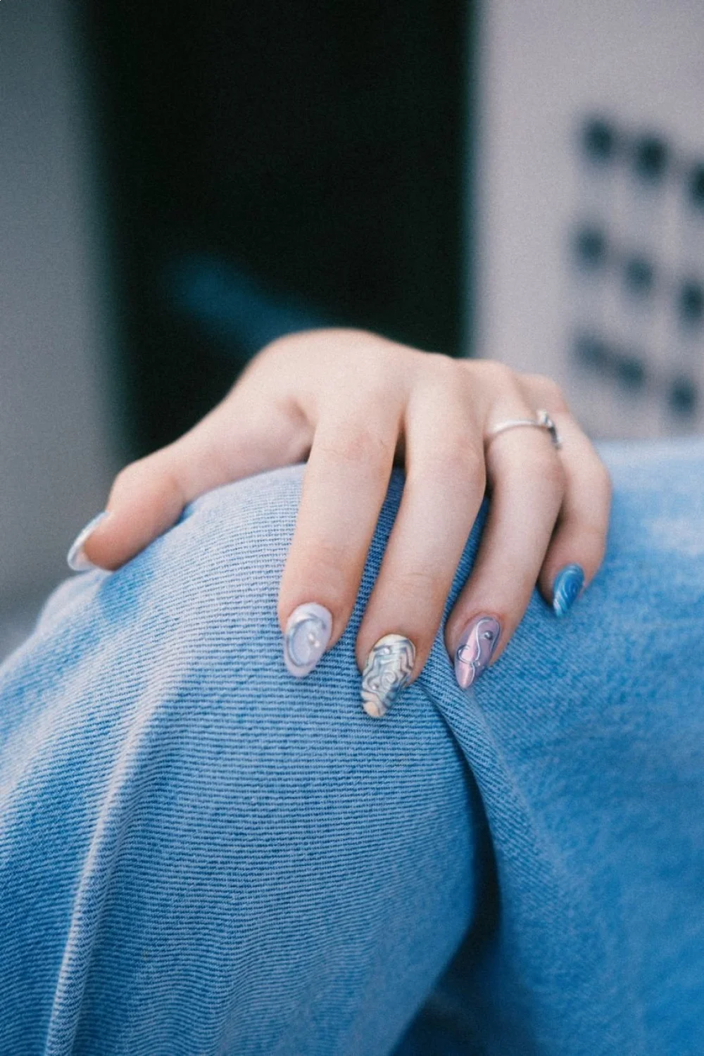 Watercolor nail art with soft blended pink, purple, and blue colors on long nails showcasing easy pretty nail designs