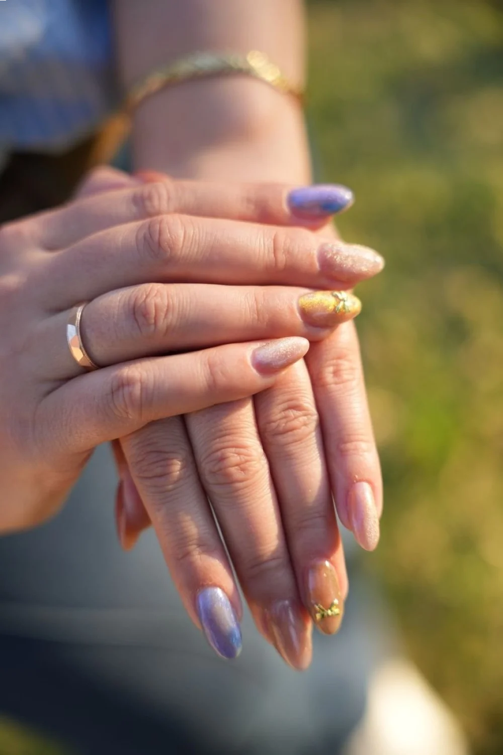 coral pink and lavender nails with gold foil accents on almond-shaped tips showcasing easy pretty nail designs