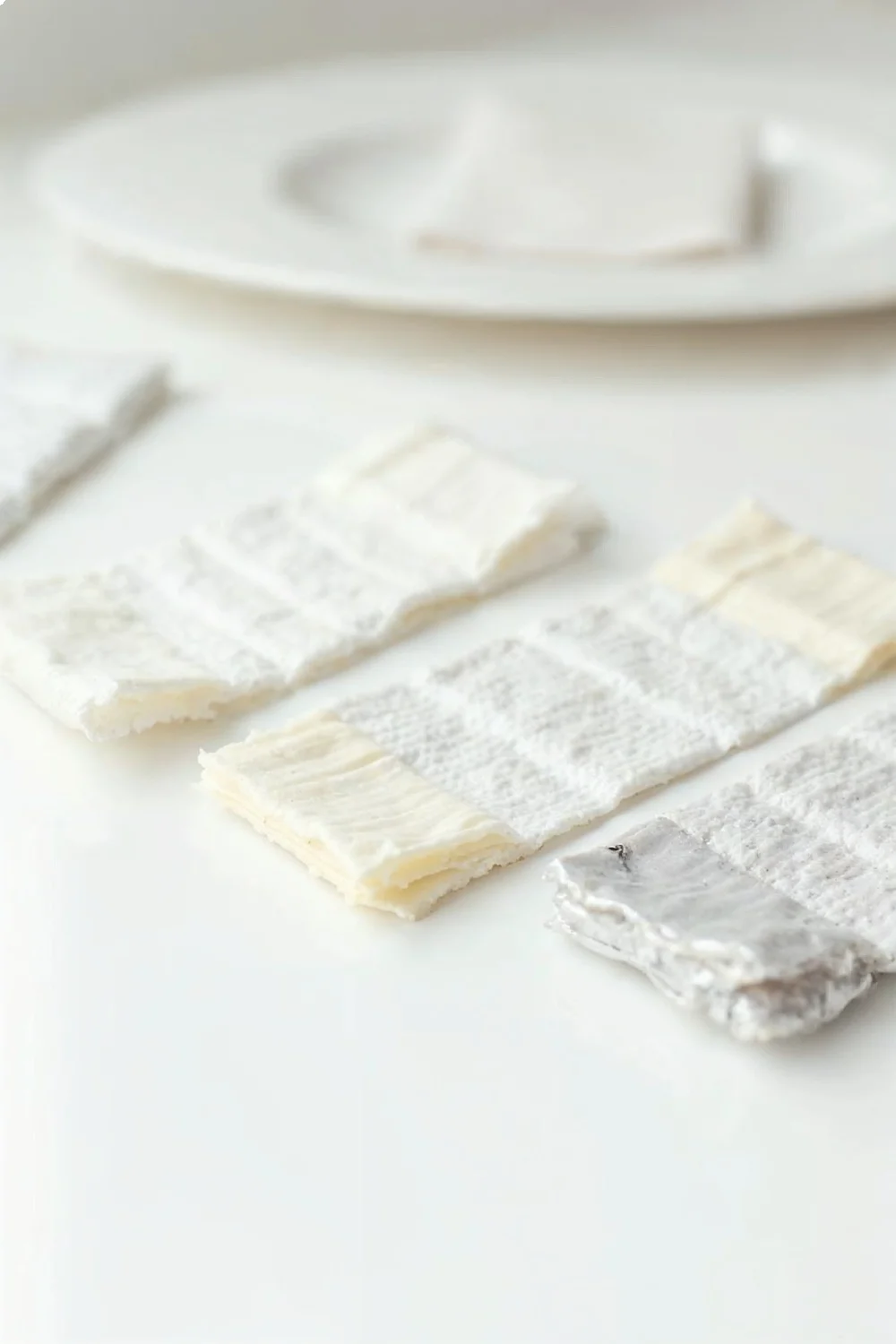 Three gel nail removal methods laid out: acetone clips, pre-soaked pads, and foil wraps on a white surface