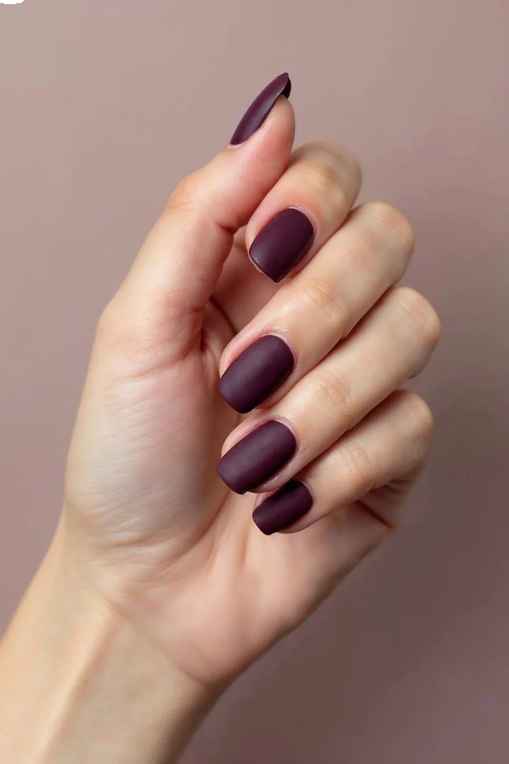 Deep plum matte nail designs on short, rounded nails with uniform texture