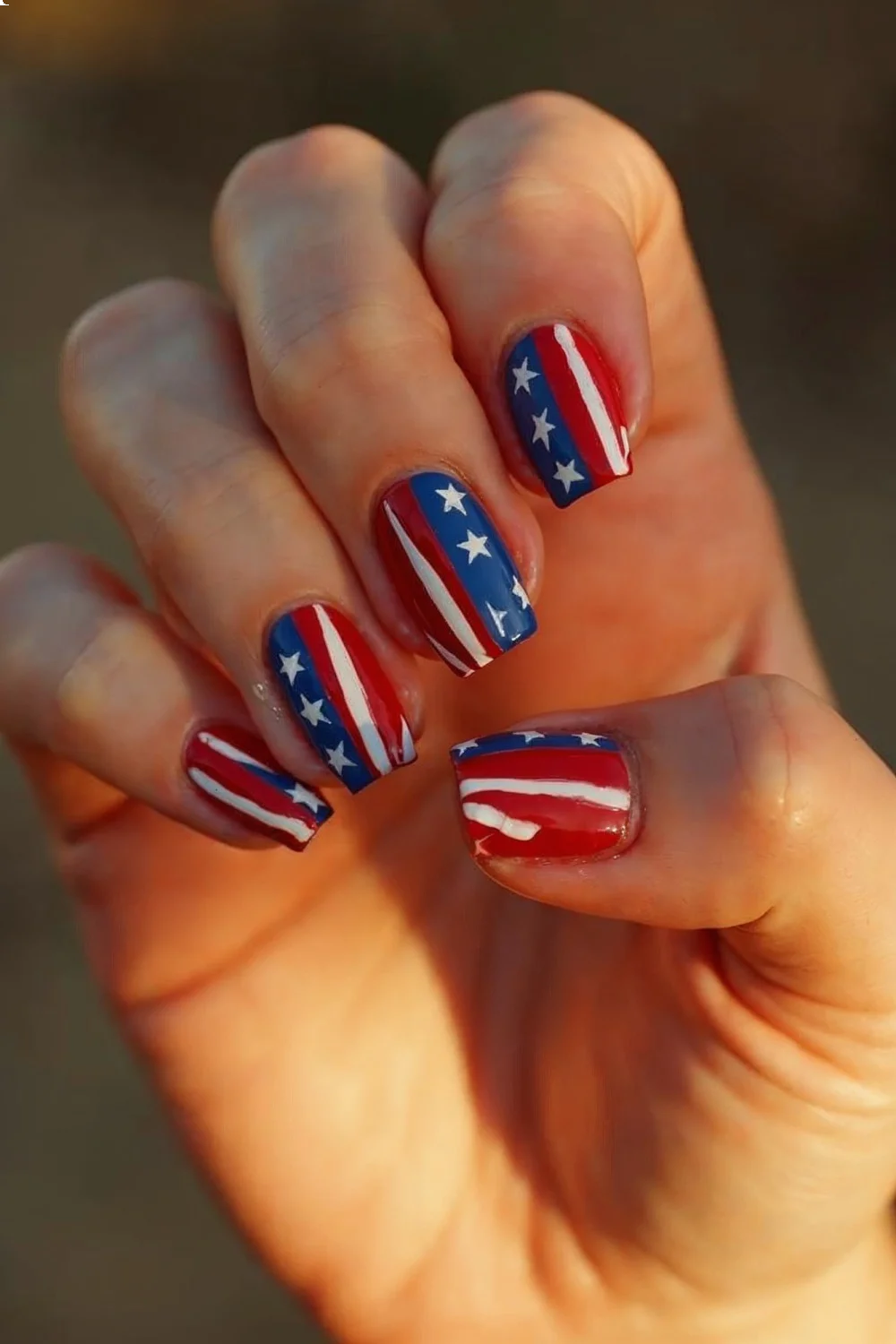 Vertical red, white, and blue stripes on short square nails showcasing clean division lines for memorial day nails