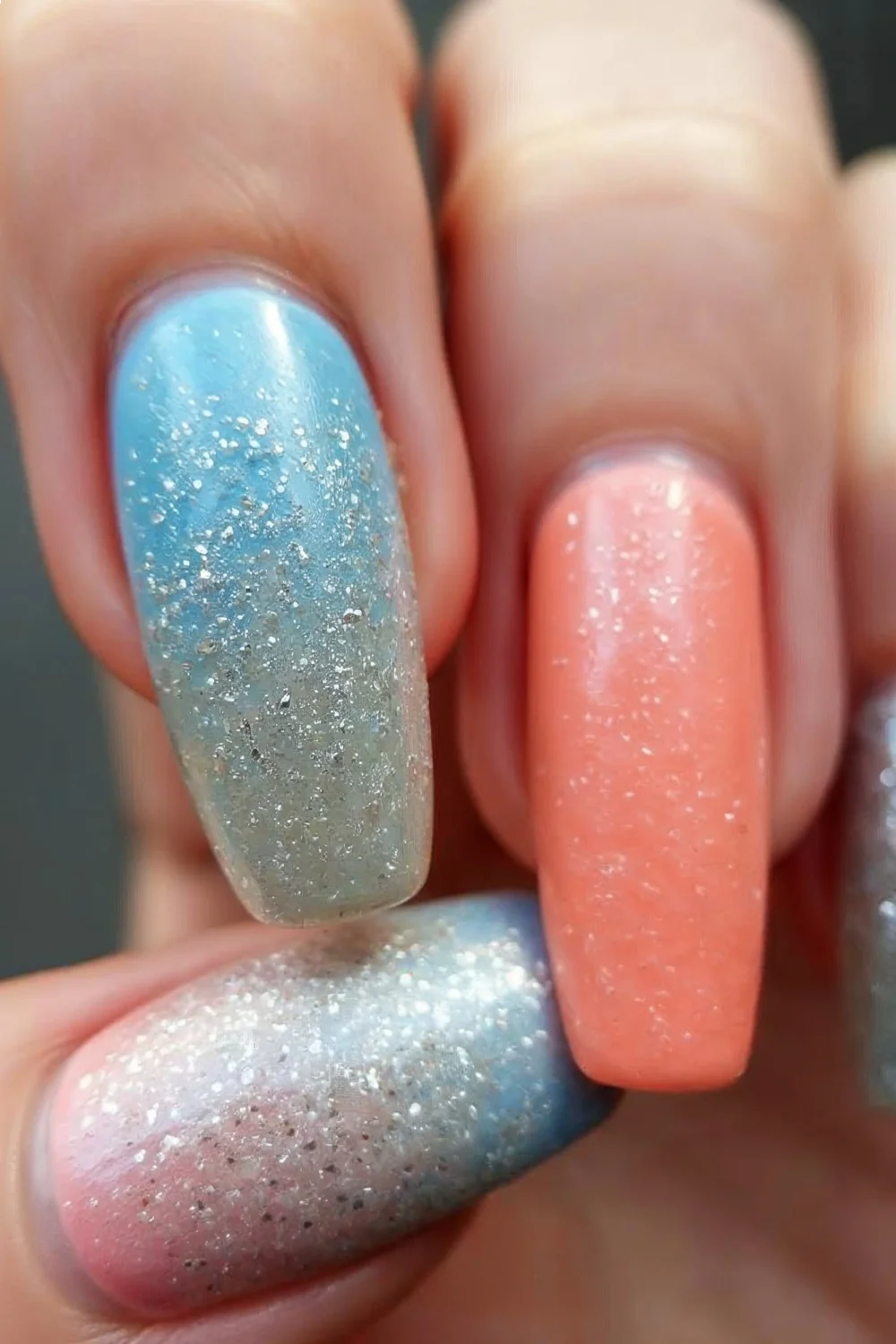 textured gradient nails with blue, coral pink, and silver glitter accents showcasing short nail designs