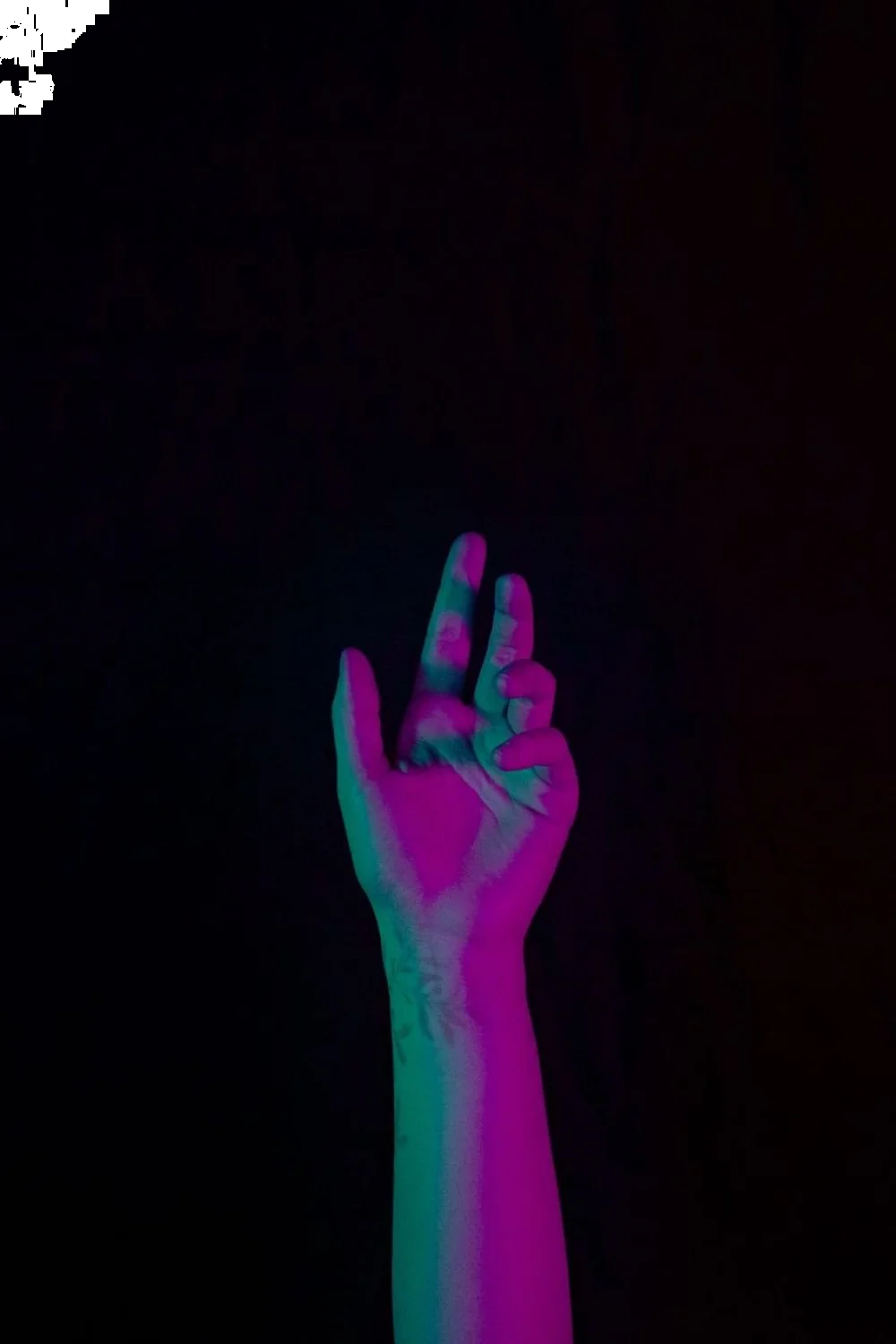 Neon tropical leaves on black base, hand pose under natural and UV light, showcasing tropical nail designs
