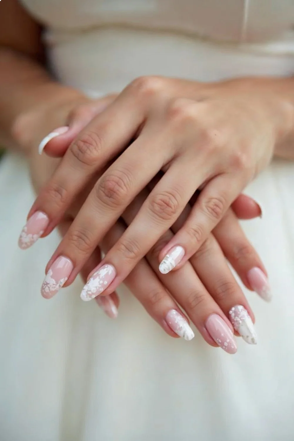 coral pink french tips with white floral designs on almond wedding nails